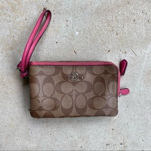 Classic leather Coach wristlet with pink trim